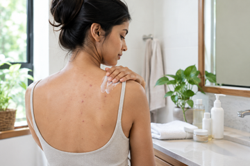 Body acne skincare routine with acne treatment products and gentle body care.